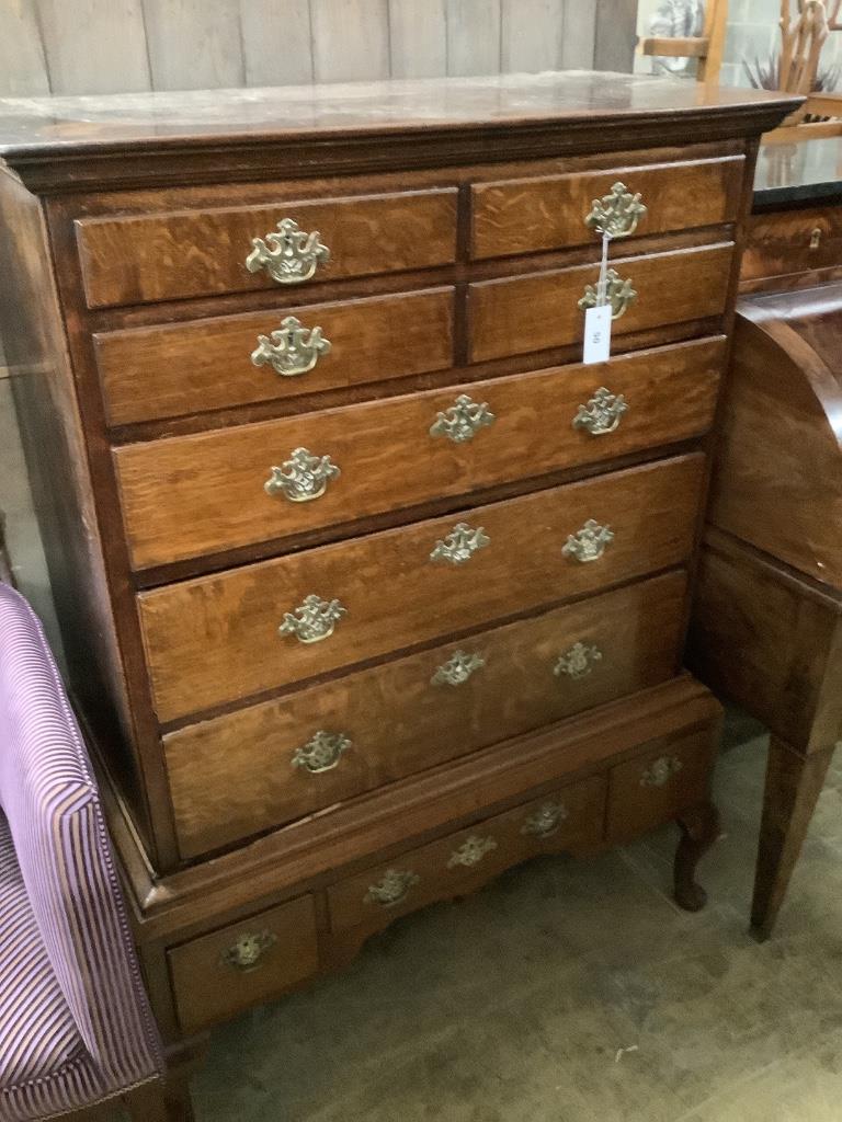 An 18th century oak chest on stand, width 100cm, depth 54cm, height 140cm